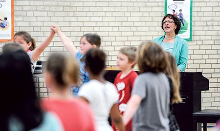 Music teacher Margo Bissen cheers after Southgate third-graders. 