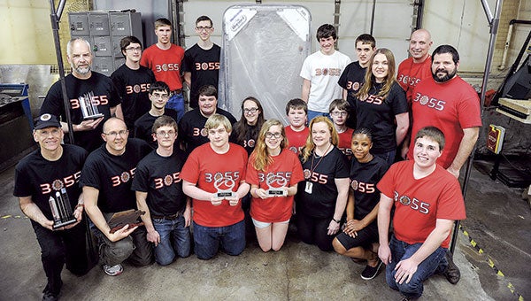 The Austin High School Robotics Team poses with the robot they will take to the Minnesota State High School League’s state tournament May 16.  Eric Johnson/photodesk@austindailyherald.com