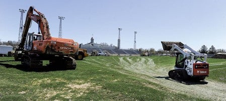 Crews got machinery going and starting intial digging Wednesday in the process to install artifical turf at Art Hass Stadium. Eric Johnson/photodesk@austindailyherald.com