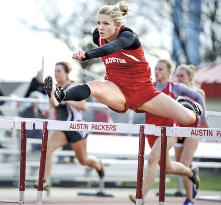 Austin's Rachel Quandt clears a hurdle during the 100-meter hurdles Tuesday afternoon during a triangular against Mankato West and Faribault. Eric Johnson/photodesk@austindailyherald.com