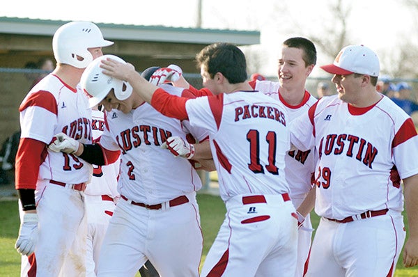Austin's Nik Gasner is greeted by his teammates after he hit a 2-run homer in the fifth inning against Rochester John Marshall in Dick Seltz Field Tuesday. Rocky Hulne/sports@austindailyherald.com
