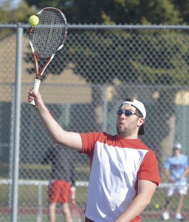 Austin's Carter Steichen makes a play on the ball in his No. 1 doubles match against Albert Lea at Paulson Tennis Courts Saturday. Rocky Hulne/sports@austindailyherald.com