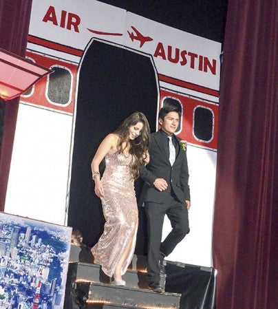Kim Macias and Franco Ortiz descend to the stage of Knowlton Auditorium at Austin High School during Grand March Saturday. 