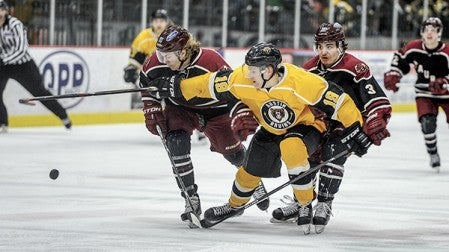 The Bruins Nico Sturm tries to pinch through Minot's Casey Johnson, left, and Max Mettler (3) during the second period in game five of the NAHL Central Division series at Riverside Arena Monday night. Eric Johnson/photodesk@austindailyherald.com
