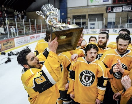 Austin's Jake Arroyo hefts the NAHL Central Division championship cup after defeating Minot in game five Monday night in Riverside Arena. Eric Johnson/photodesk@austindailyherald.com