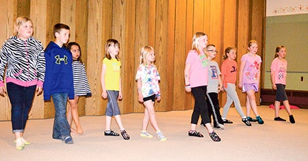 More than a dozen students all participate in an Irish dance drill Thursday at Little Cedar Lutheran Church in Adams. 