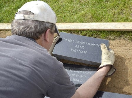 Anderson Memorial owner Jeff Anderson places a batch of 55 pavers at the Mower County Veterans Memorial Friday afternoon in preperation for Memorial Day. After a string of sales, 1,028 pavers have sold and the project is nearing the goal of 1,056 pavers. Jason Schoonover/jason.schoonover@austindailyherald.com