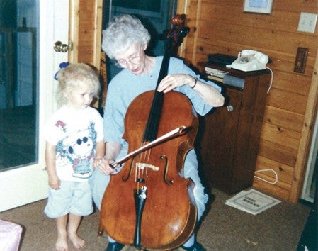 Jean Miller (right) plays her cello for her Goddaughter, Halla Nelson, in 1996. Miller was also the Godmother of Halla's mom, Erleen Nelson, who said Miller instilled a love of music in both her and her daughter. Photo provided.
