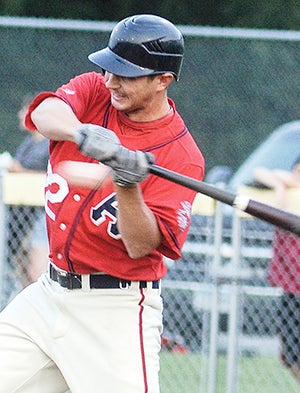 The Austin Greyhounds’ Andy Swank holds on a pitch against the Blue Sox last season at Marcusen Park. Herald file photo