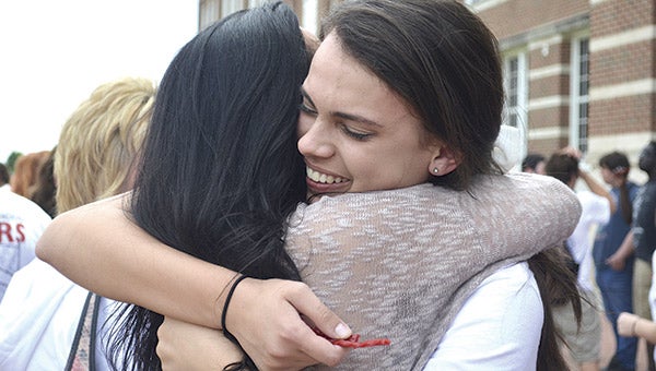 Austin High School senior Kennedy Novy hugs her mother Kim Hepler after the last walk-through of the building for the 2015 graduating class.