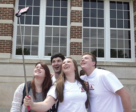 Ashley Harrington (left), Isaac Schumacher, Kendall Hull and Max Deyo stand to take a selfie with Hull’s phone on the last day of school for the seniors. 