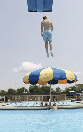 A boy dives into the diving pool.