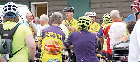 Tour of Minnesota ride director Bob Lincoln talks to riders Monday morning before they left to travel to Albert Lea