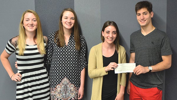 Austin High School’s Youth Leadership inituative presents a $2,500 check to The Hormel Institute on Tuesday. Picture, from left, are students Madison Overby and Sarah Willrodt, Kelsey Boland of The Hormel Institute, and student Giancarlo Marconi. -- Photo provided