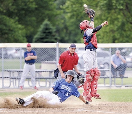 Austin VFW catcher Phillip Zynda tries to bring down a high throw as Northfield’s Hunter Koep slides into home in the first inning of game one Wednesday night at Marcusen Park. Eric Johnson/photodesk@austindailyherald.com