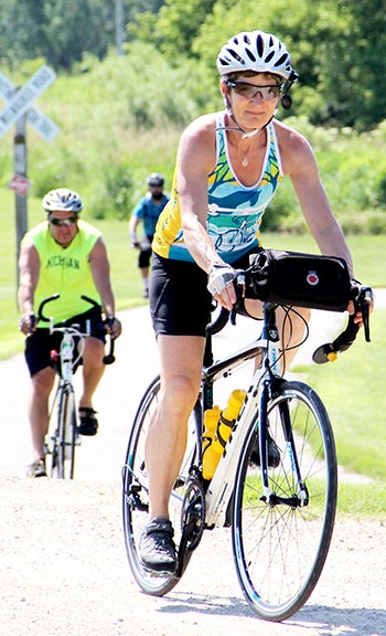 Laurene Kruger of Grafton, Iowa, nears a stop at the Rose Pedaler in Rose Creek during the 40-mile stretch of the ride on Saturday.