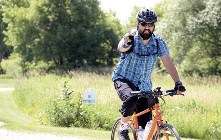 Michael Tschida nears a stop at the Rose Pedaler in Rose Creek during the 40-mile stretch of the annual Shooting Star Trail Bike Ride on Saturday.  -- Photos by Jason Schoonover