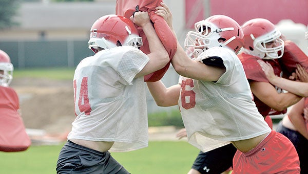 Austin's sam Diggins, left, and Jackson Hampple battle during a summer workout for the Packer football team at Wescott Monday. The Packers will kick off their season Aug. 22. Rocky Hulne/sports@austindailyherald.com