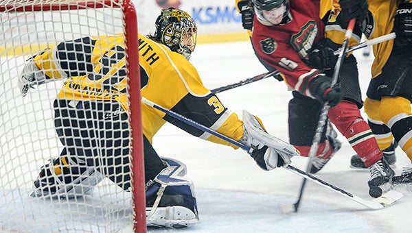 Austin Bruins goalie Evan Smith knocks the puck away from the crease in the first period against the Minnesota Wilderness in game one of the Robertson Cup championship series in May at Riverside Arena. Herald file photo