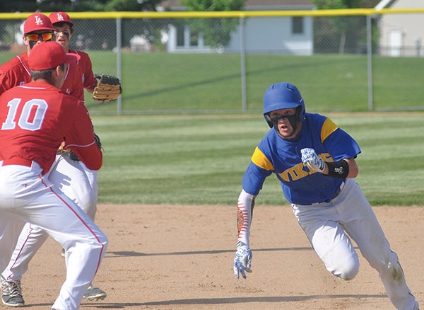 Hayfield’s Andrew Becker tries to get back to first after being caught in a run-down by Lewiston-Altura in Rochester Wednesday.  Photos by Rocky Hulne/sports@austindailyherald.com