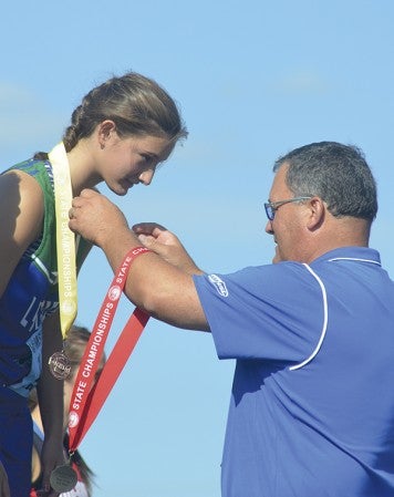 Lyle-Pacelli's Sarah Holtz receives her fourth place medal for the high jump at the Minnesota Class A state track and field meet in Hamline University Friday. Rocky Hulne/sports@austindailyherald.com