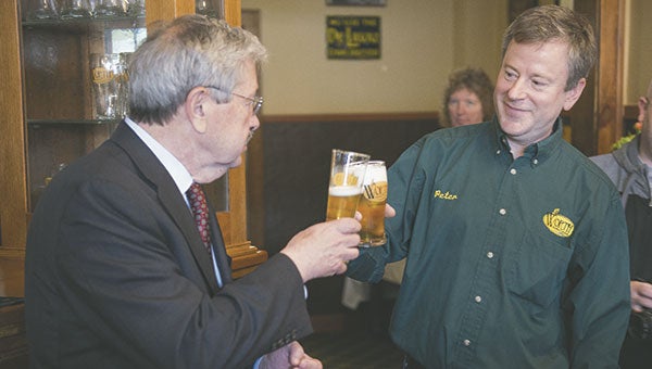 Iowa Gov. Terry Branstad and Worth Brewing Co. owner Peter Ausenhus toast the company’s expansion plans June 12 in Northwood. Photos by Colleen Harrison/Albert Lea Tribune
