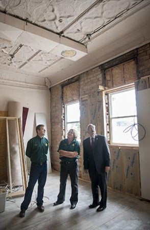 Worth Brewing Co. owners Peter Ausenhus and Margaret Bishop take Gov. Terry Branstad on a tour of their brewery's future expansion location Friday during the governor's stop in Northwood Friday. Colleen Harrison/Albert Lea Tribune