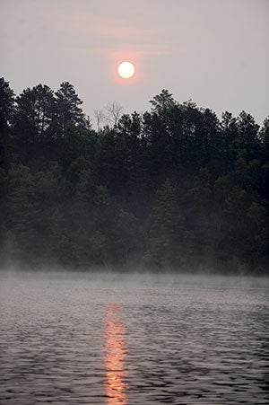 Haze turns the morning sun red as it rises over Bad Axe Lake in north central Minnesota last week.  Eric Johnson/photodesk @austindailyherald.com