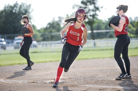 Austin Red’s Ally Wood rounds third on the way to scoring against the Stewartville Rebels Tuesday night at Todd Park. Eric Johnson/photodesk@austindailyherald.com