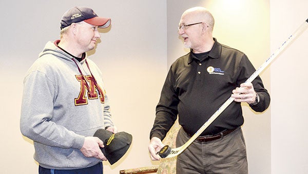 Scott McConkey, right, of the Office of Traffic Safety presents Austin Police Sgt. Jeff McCormack in March with a hockey stick symbolizing a Hat Trick Award for processing three drunk driving cases during shifts on April 26 and June 26, 2014. Herald file photo