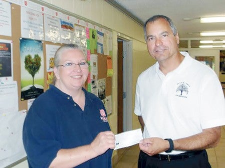 Salvation Army Social Services Director Lori Espe accepts a check for $1,000 from Austin Area Foundation Executive Director Jeff Baldus. Photo provided