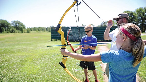 Nine-year-old Chelsea Christopherson sites in her shot as friend Isaac Fjerstadt prepares his next shot during 2015 JAKES/PF Day Saturday at the Cedar Valley Conservation Club. Photos by Eric Johnson