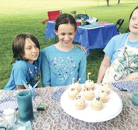 12-year-old Raistlyn Kline, center, and her friends were treated to cupcakes during their painting party at Veteran’s Park Tuesday. Photos provided