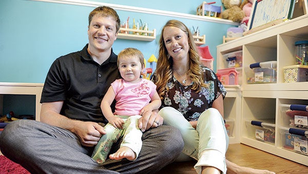 The Leopolds — Tyler, Mandy and two-year-old Elliana — hang out in Elliana’s playroom. Elliana is one of two honorary chairs for this year’s Relay for Life.  Eric Johnson/photodesk@austindailyherald.com