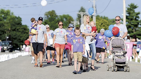 Seven-year-old Carter Simonson leads the survivors walk during the Relay for Life Saturday night at the Mower County Fairgrounds.  Eric Johnson/photodesk@austindaily herald.com