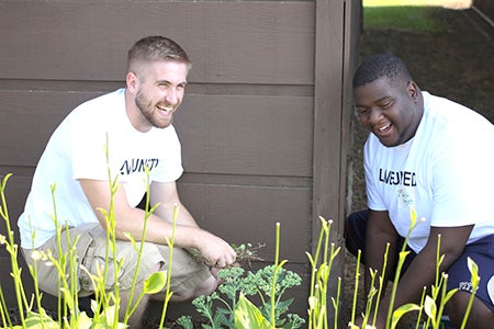 Two Hormel interns smile while working on a Day of Caring project. -- Photo provided