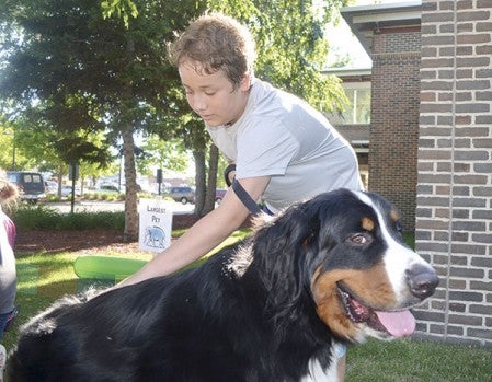 Bryce Garroway pets his dog, Sherlock.
