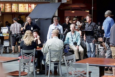 Director of Photography Fred Elmes, center with camera around neck, other crew members and actor stand-ins prepared to shoot a scene of “Wilson” at the Mall of America in Bloomington, Minnesota on July 14. Jeffrey Thompson/MPR News