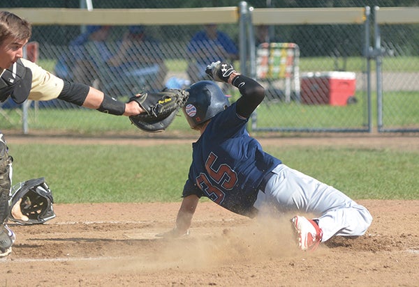 Evan McAlister of Austin Post 1216 slides past a tag at home plate against the Rochester Knights in Marcusen Park Saturday. Rocky Hulne/sports@austindailyherald.com