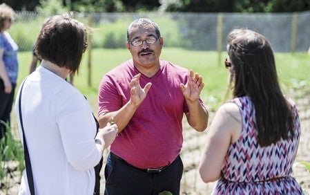 Victor Contreras, with The Latino Economic Development Center, talks with Mary Holtorf, left, and Tessa Donato of Lingua One during a recent open house for the La Surena Cooperative site near Woodson Kindergarten Center.  Eric Johnson/photodesk@austindailyherald.com