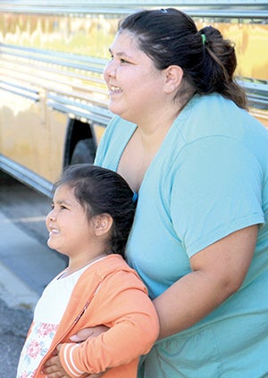 Nevaeh Pineda poses for a photo with her mom, Paige, outside Woodson Kindergarten Center on Monday. 