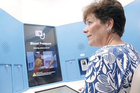 Rep. Peggy Bennett, R-Albert Lea, sits in a Mayo Clinic Health Connection kiosk at 408 Fourth Ave. NW near Austin High School Wednesday afternoon.