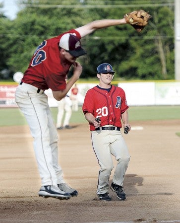 The Austin Greyhounds’ Josh Evans pulls into third base as the ball shoots over the bag.