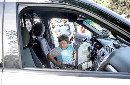 Five-year-old Liam Kirby checks out the inside of a police cruiser.