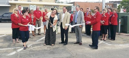 Austin Area Chamber of Commerce Ambassadors and Austin Utilities held a ribbon cutting for the solar electrical vehicle charging station Wednesday at the municipal parking lot at Third Avenue and First Street Northwest.