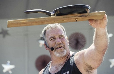 Strongman John Beatty shows off a nail he drove through a frying pan and piece of wood with his hand. Eric Johnson/photodesk@austindailyherald.com