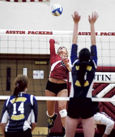 Austin’s Ashley Hawkshead hits from the back row during game one of the Packers’ match against Rochester Lourdes Thursday night in Packer Gym. Eric Johnson/photodesk@austindailyherald.com