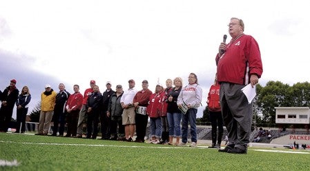 Superintendent David Krenz leads a presentation to introduce those involved in getting artificial turf down at Art Hass Field and the adjacent soccer field before the Packers’ game against Winona Friday night.  Eric Johnson/photodesk@austindailyherald.com