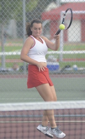 Austin's Jennifer Bogle makes a play on the ball in her No. 1 singles match against Rochester Century at Paulson tennis courts Thursday. Rocky Hulne/sports@austindailyherald.com