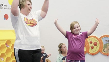 Jamie Riley, left, goes through moves with her daught, Ella, 7, during the first Special Olympics Young Athletes Program at the Austin YMCA Wednesday, Sept. 16. The program continues weekly through Nov. 4. Jason Schoonover/jason.schoonover@austindailyherald.com